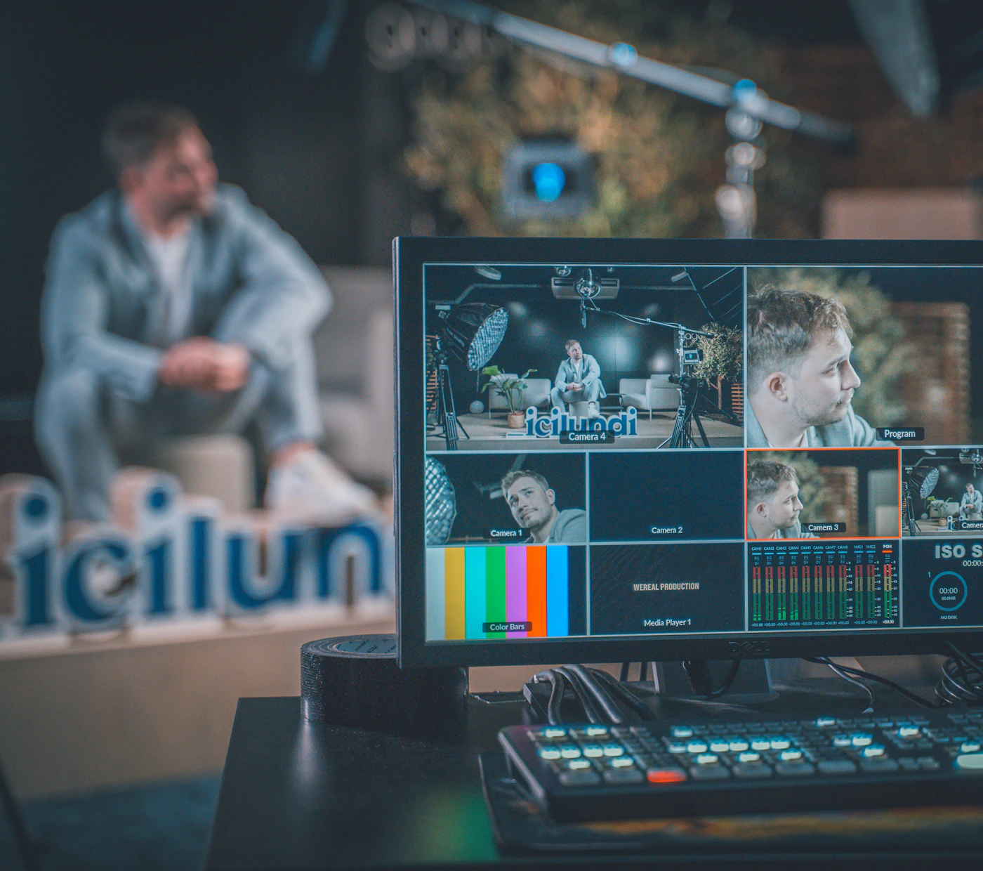 Video production desk with a monitor showing multiple camera feeds